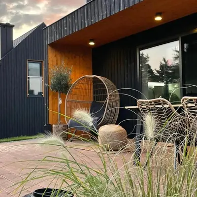 a house with chairs and plants in front of it at BonnieClyde in Beattock