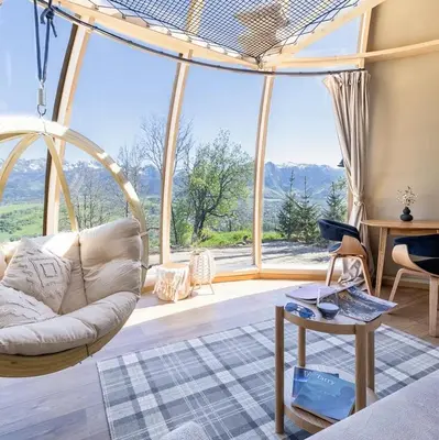 a living room with a couch and a large window at BonnieClyde in Beattock