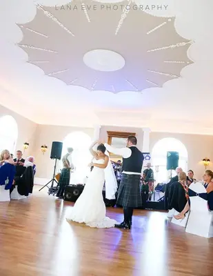 a bride and groom dancing in a room at Forrester Park Resort in Dunfermline