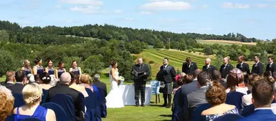a bride and groom walking down the aisle at their wedding at Forrester Park Resort in Dunfermline