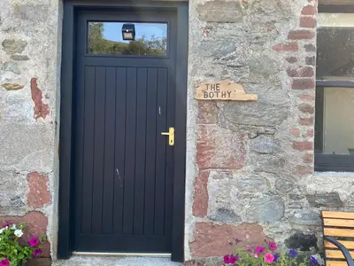 a black door with a sign that reads the bottom at The Bothy at Christmas Cottage in Rowardennan