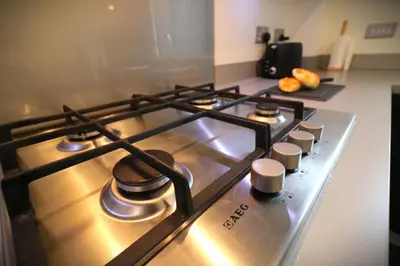 a stove top with some pots and pans on it at Signature - Oatlands House in Glasgow