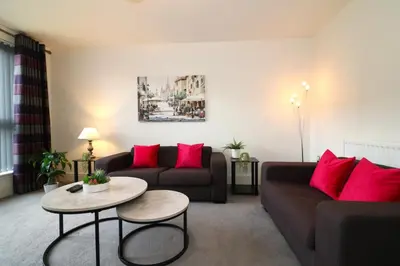 a living room with two couches and a table at Signature - Oatlands House in Glasgow