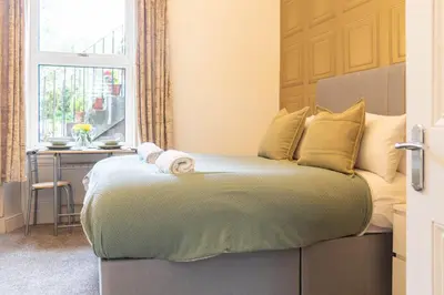 a bedroom with a bed with a window and a desk at Renton Apartment in Renton