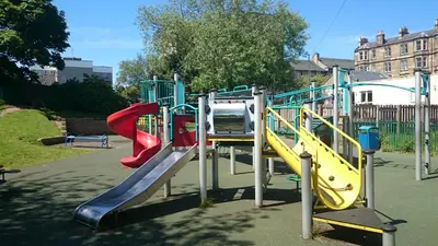 a playground with several slides and slidesktop at Violet Bank Apartment Morningside in Edinburgh