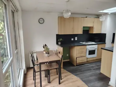 a kitchen with a table and chairs in a room at Bright Edinburgh Flat - City Center EB7 in Edinburgh