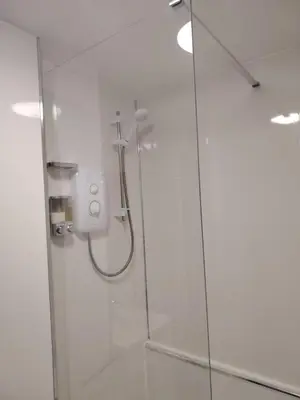 a bathroom with a shower with a glass door at Bright Edinburgh Flat - City Center EB7 in Edinburgh