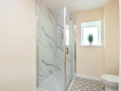 a glass shower in a bathroom with a toilet at The Barn, Drumbow Farm in Airdrie