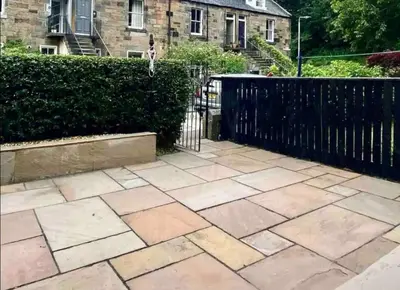 a garden with a fence and a patio at amazing apartments - Avondale Pl by Stockbridge in Edinburgh