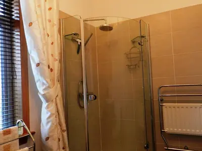 a shower with a glass door in a bathroom at Goatfell View in Brodick