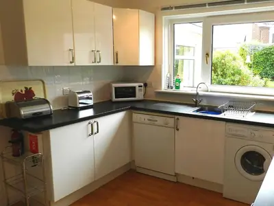 a kitchen with a sink and a microwave at Hartholm in Brodick