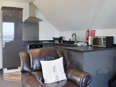 a leather chair with a pillow on it in a kitchen at Woodlea Cottage 1 in Dippin