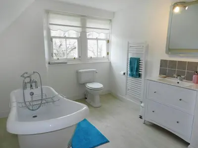 a white bathroom with a sink and a toilet at Craegard House in Corrie