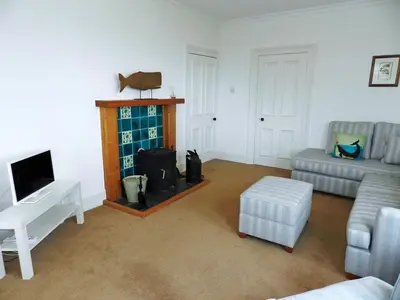 a living room with a couch and a fireplace at Craegard House in Corrie