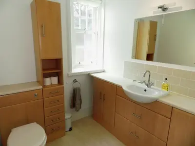 a bathroom with a sink and a toilet and a mirror at Craegard House in Corrie