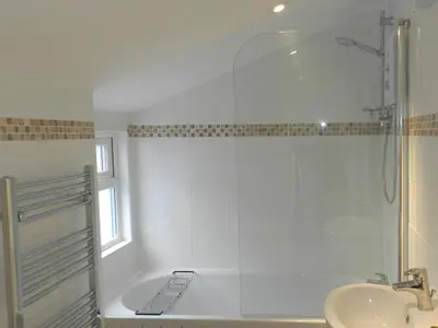 a bathroom with a shower and a sink at Hamilton Terrace in Lamlash