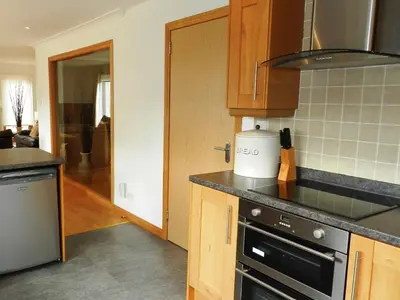 a kitchen with a stove and a counter top at Glen Rosa Lodge in Brodick