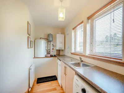 a kitchen with a sink and a refrigerator at Sky View in Ardmaleish