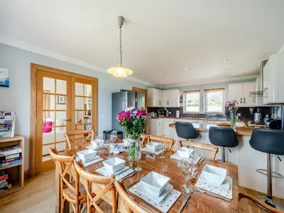a kitchen and dining room with a table and chairs at Sky View in Ardmaleish