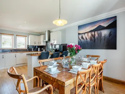 a kitchen and dining room with a table and chairs at Sky View in Ardmaleish