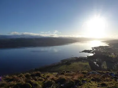 a view of a body of water with the sun in the sky at Crosskeys Cottage in Shandon