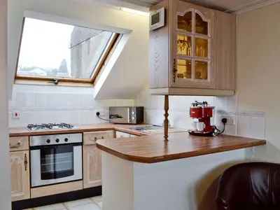a small kitchen with a counter and a window at Apartment Sea View in Hunters Quay