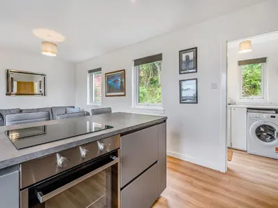 a kitchen with a sink and a dishwasher at Sea Breeze Cottage in Lochranza