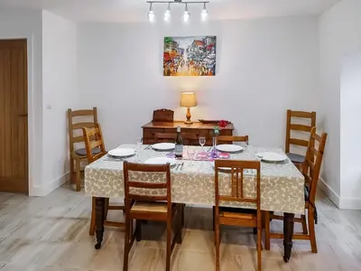a dining room with a table and chairs at Old Steading in Brodick