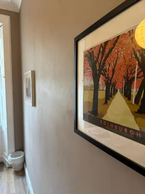 a painting hanging on a wall in a room at Central Room In Historic Tenement Shared Apartment Near Old Town in Edinburgh