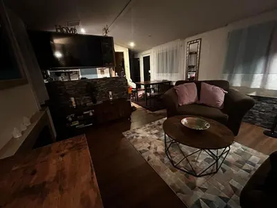 a living room with a couch and a table at 23 Chestnut Grove in Kirkcolm