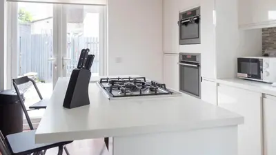 a kitchen with a stove and a white counter top at Moncrieff House in Livingston