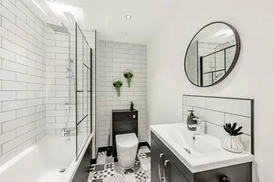a bathroom with a sink and a toilet and a mirror at Cowden Coorie in Fife