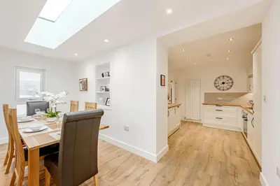 a kitchen and dining room with a dining table and a dining room at Cowden Coorie in Fife