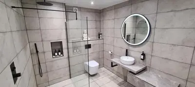 a bathroom with a toilet and a mirror at The Old Courthouse in Rothesay