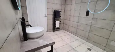 a bathroom with a white sink and a shower at The Old Courthouse in Rothesay