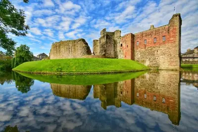 a castle with its reflection in the water at The Old Courthouse in Rothesay