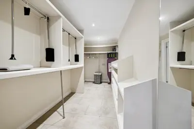 a room with white shelves and a hallway at Timeless 5 bed Duplex Flat in Glasgow