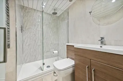 a bathroom with a shower and a toilet and a sink at Timeless 5 bed Duplex Flat in Glasgow