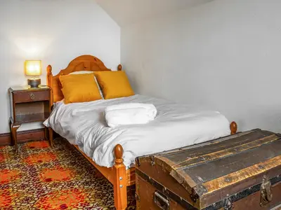 a bedroom with a bed with an old trunk next to it at Burncliff in Blackwaterfoot