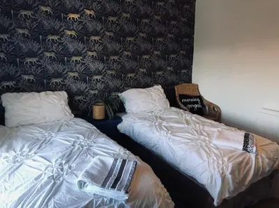 two beds sitting next to each other in a room at House in Drymen Village with free local health club access in Glasgow