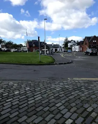 a brick street with a parking lot with houses at House in Drymen Village with free local health club access in Glasgow