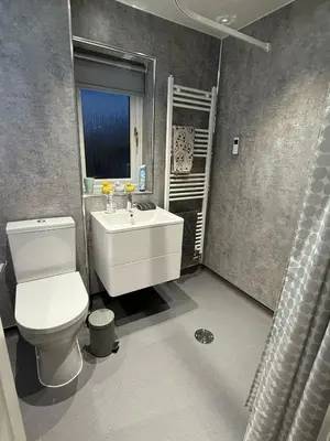 a bathroom with a white toilet and a sink at Single room with beautiful garden in Edinburgh