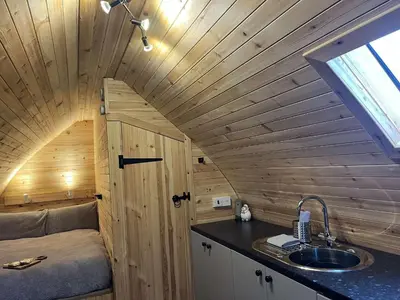 a tiny house with a sink and a bathroom at Penny gown farm pod in Campbeltown