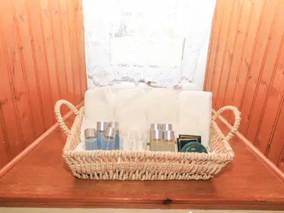 a basket with towels and other items on a table at Hazel's Cottage in Campbeltown