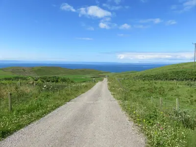 a dirt road in the middle of a field at Hazel's Cottage in Campbeltown