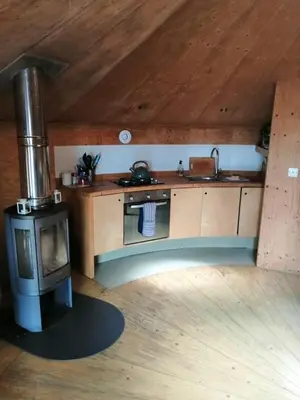 a kitchen with a stove and a stove top oven at Otter - Eco Bothy with Hot Tub in Castle Douglas