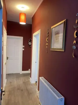a hallway with purple walls and a white door at 2 Bedrooms Holiday home in Edinburgh near City Center in Edinburgh