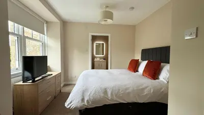 a bedroom with a bed and a flat screen tv at 19 Snowdon Apartment in Stirling