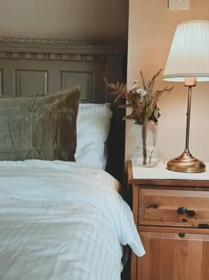 a bedroom with a bed and a lamp on a night stand at Loch Lomond 2 Bedroom Apartment in Tarbet