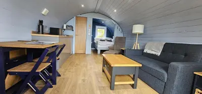 a living room with a couch and a table at Kintyre Glamping Pods in Campbeltown